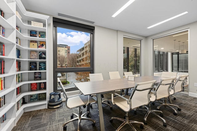 interior space featuring a wealth of natural light, carpet flooring, and visible vents