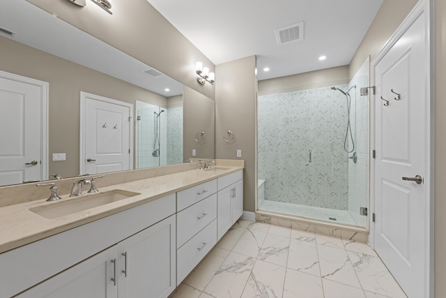 full bathroom featuring marble finish floor, a sink, visible vents, and a shower stall