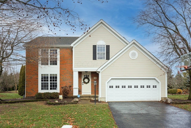 view of front of property featuring a front yard and a garage