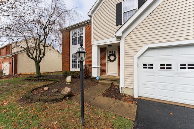 doorway to property with a garage