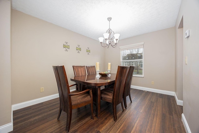 dining space featuring dark hardwood / wood-style flooring, a chandelier, and a textured ceiling