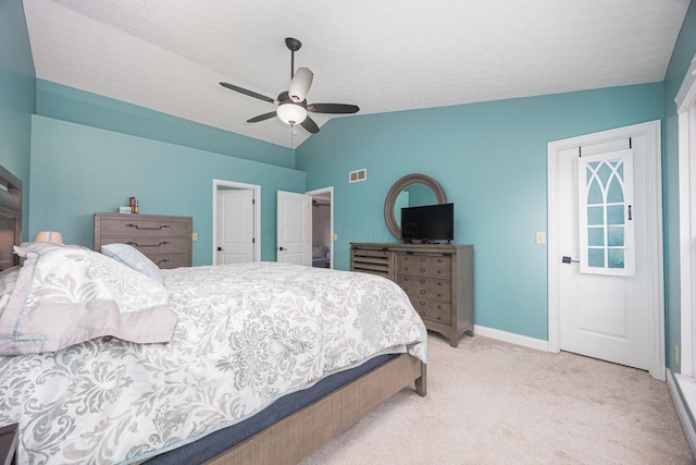 carpeted bedroom featuring a textured ceiling, ceiling fan, and lofted ceiling