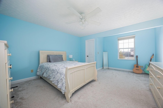 bedroom with light carpet, a textured ceiling, and ceiling fan