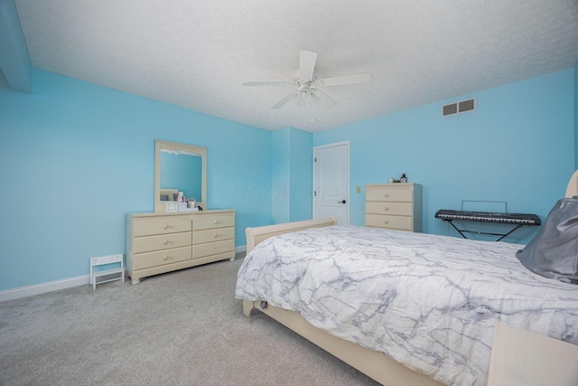 bedroom featuring ceiling fan, carpet floors, and a textured ceiling