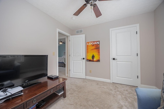 carpeted home office featuring a textured ceiling