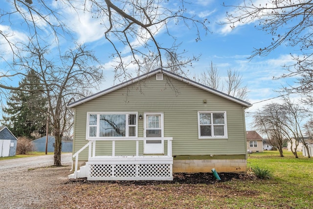 back of property featuring a lawn