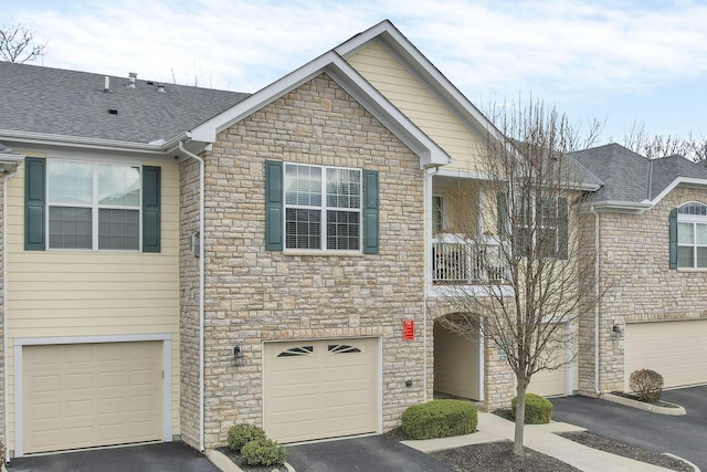 view of front of house featuring a balcony and a garage