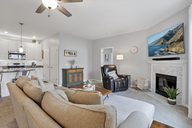 living room featuring ceiling fan and light carpet