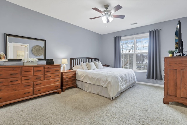 bedroom with ceiling fan and light colored carpet