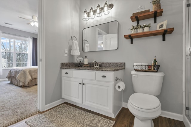 bathroom with ceiling fan, toilet, wood-type flooring, and vanity