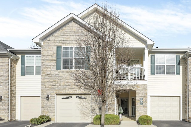 multi unit property with a balcony and a garage