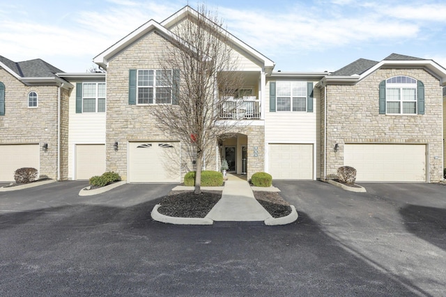 multi unit property featuring a balcony and a garage