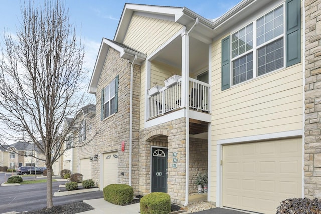 view of front of house featuring a balcony and a garage