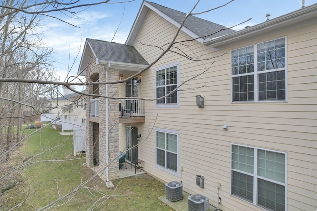 back of house featuring a balcony and central air condition unit