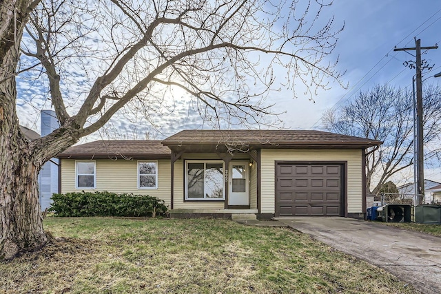 ranch-style home featuring a garage and a front lawn