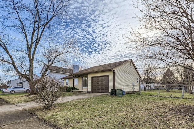 view of front of property with a front yard and a garage