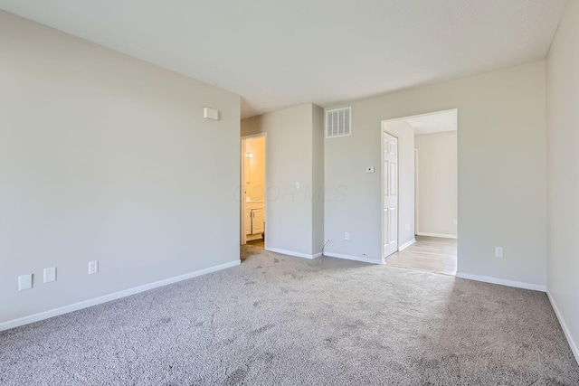 empty room featuring light colored carpet