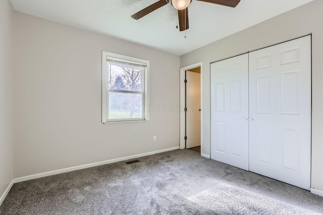 unfurnished bedroom featuring carpet floors, a closet, and ceiling fan