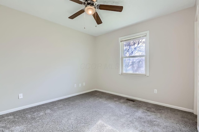 carpeted spare room featuring ceiling fan