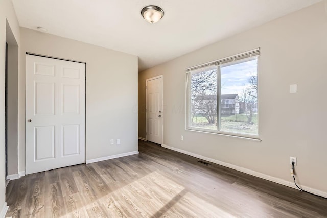 unfurnished bedroom with wood-type flooring