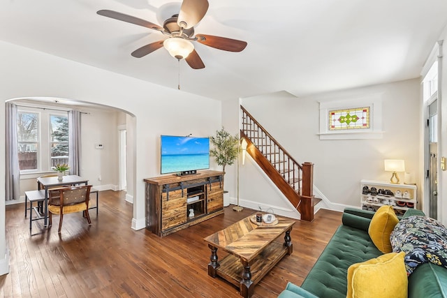 living room featuring a wealth of natural light, dark hardwood / wood-style floors, and ceiling fan