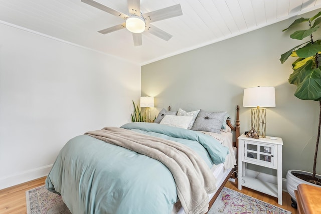 bedroom featuring hardwood / wood-style flooring, ceiling fan, and wood ceiling