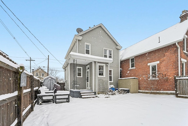 snow covered house with a shed