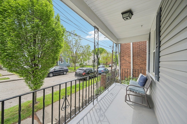 balcony with a residential view and a porch