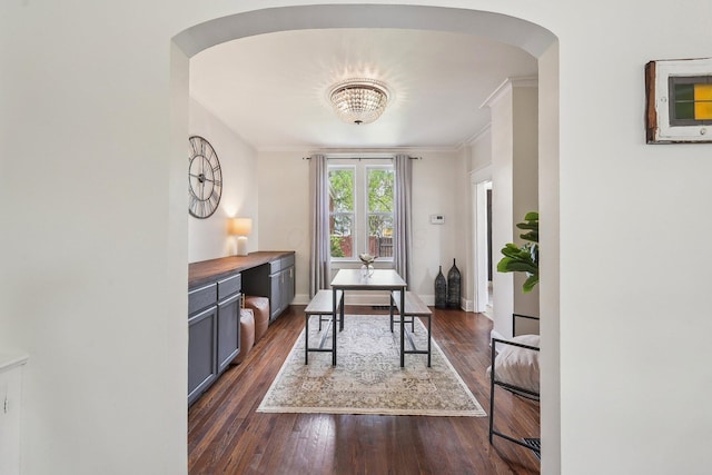 home office with baseboards, ornamental molding, arched walkways, and dark wood-style floors