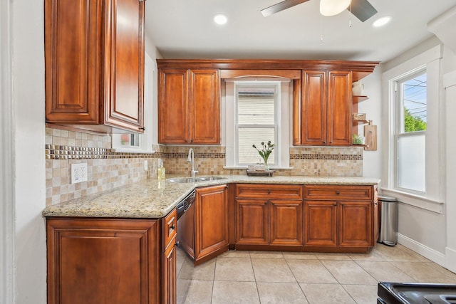 kitchen with a sink, tasteful backsplash, stainless steel dishwasher, and light tile patterned flooring