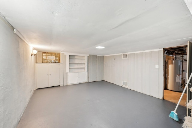 finished basement with visible vents and water heater