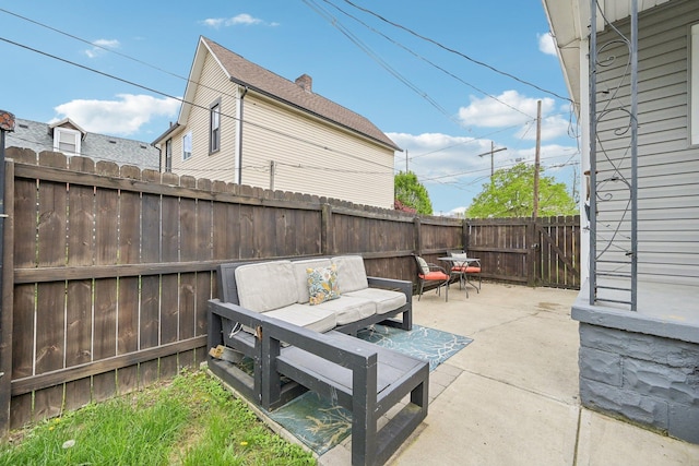 view of patio / terrace with an outdoor living space and a fenced backyard