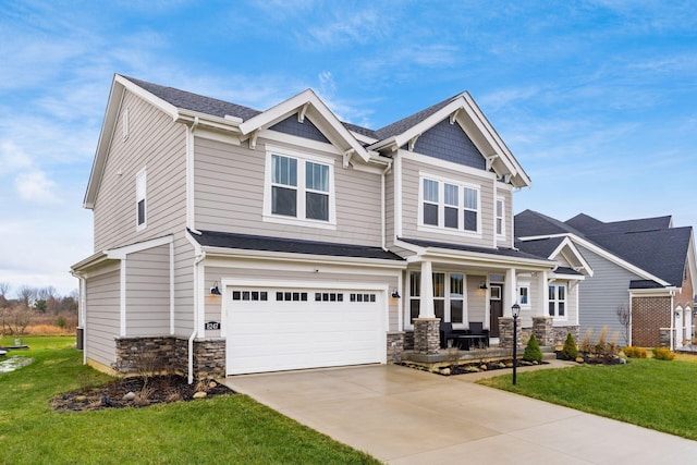 craftsman-style home with a porch, a garage, and a front lawn