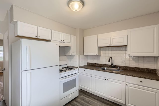 kitchen with sink, white appliances, tasteful backsplash, and white cabinets