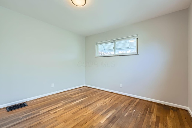 spare room featuring hardwood / wood-style flooring