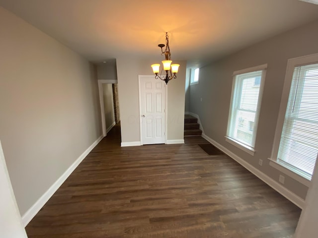 655-657 Frebis Ave, Columbus, OH 43206 - unfurnished dining area with dark hardwood / wood-style floors and a notable chandelier