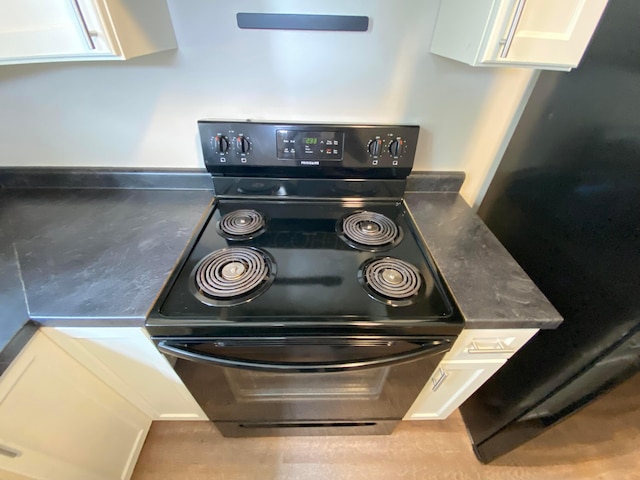 kitchen with white cabinetry and stainless steel electric range oven