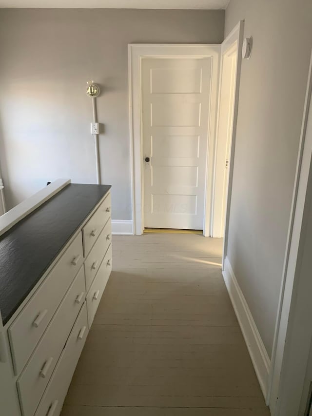 corridor featuring hardwood / wood-style floors