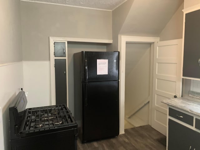 kitchen with black appliances and dark wood-type flooring