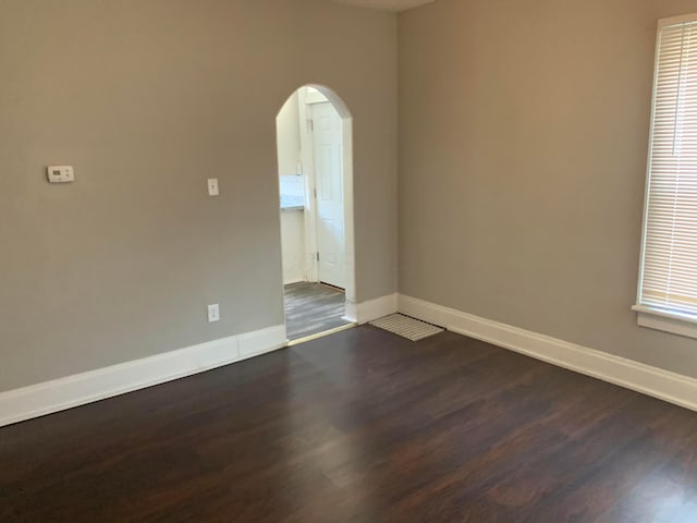 empty room with dark wood-type flooring