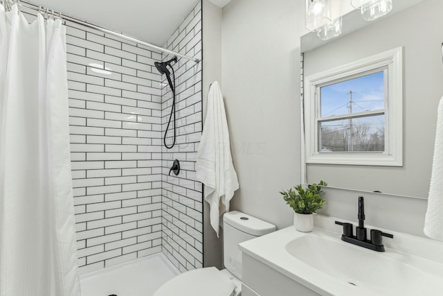 bathroom featuring toilet, vanity, and walk in shower