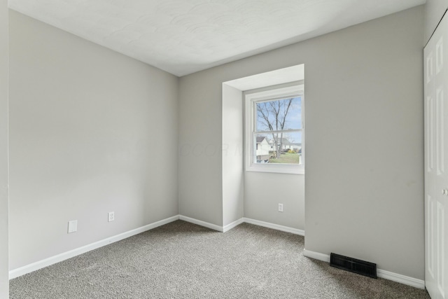 unfurnished room featuring carpet flooring