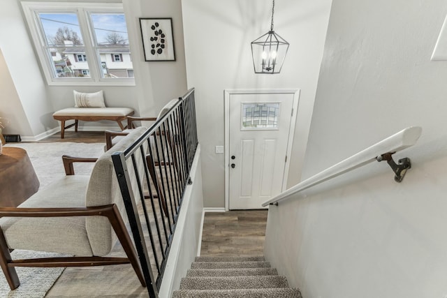 foyer with hardwood / wood-style floors and a chandelier