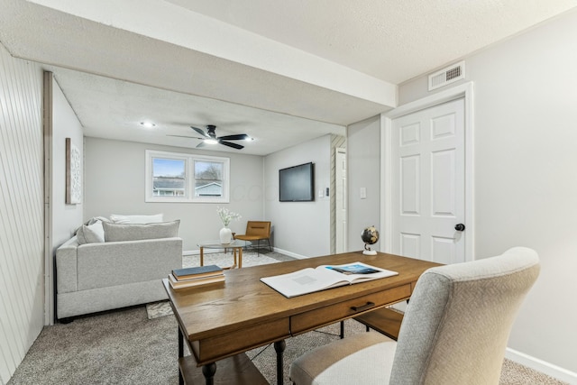 office with ceiling fan, carpet floors, and a textured ceiling