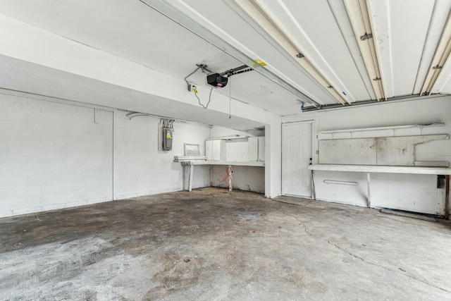 garage with electric panel and a garage door opener