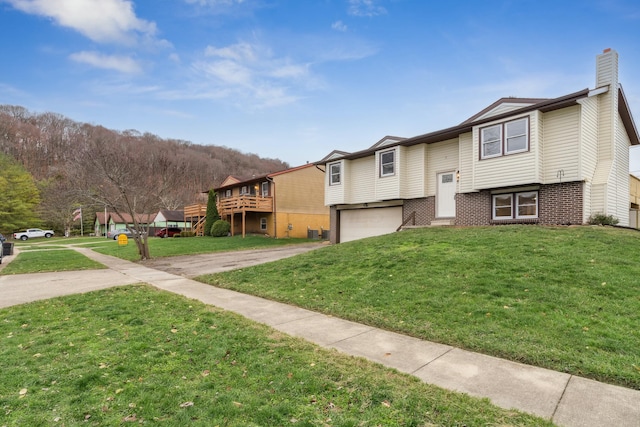 view of front of property featuring a garage and a front lawn