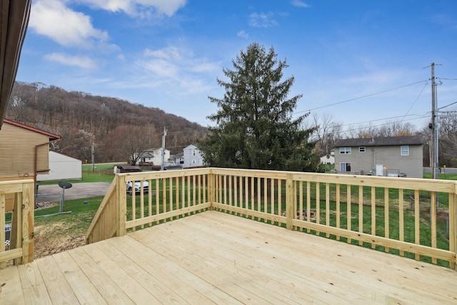 wooden terrace featuring a yard