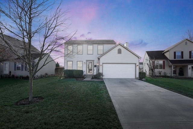 view of front facade with a lawn and a garage