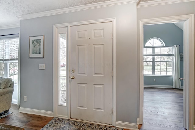 entrance foyer with a textured ceiling and ornamental molding