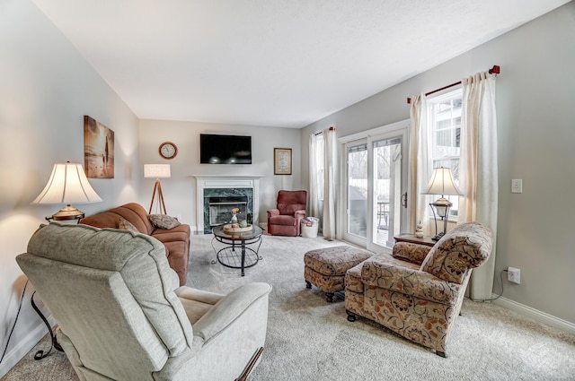 carpeted living room featuring a high end fireplace